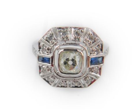 An 18ct white gold diamond and sapphire Art Deco style ring, with a central rose cut diamond flanked by two baguette cut sapp