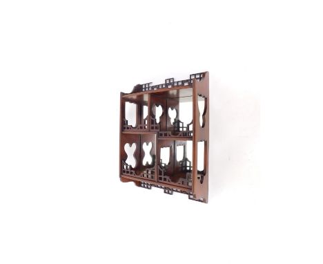 A Chinese Chippendale style mirror back wall mounted display shelves, with four staggered shelves, 62cm H, 44cm W, 17cm D.