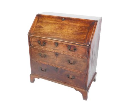 A George III mahogany bureau, the fall flap opening to reveal a central recess, flanked by six further recesses above four dr