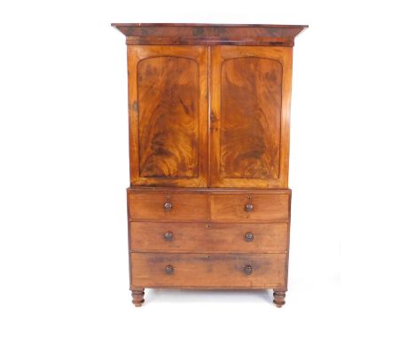 A Victorian mahogany cupboard chest, the outswept pediment over two doors enclosing a single shelf, over two short and two lo