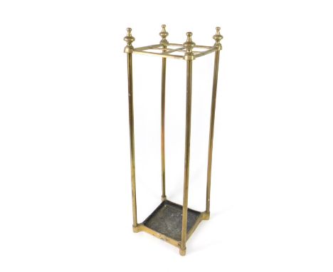 A Victorian brass four division stick stand, of square section, with cast iron drip tray, 61cm H.