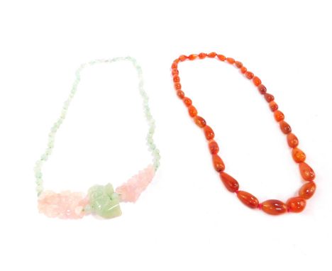 Two semi precious stone necklaces, comprising a natural orange stone pear shaped beaded necklace, on red string, and a jade a