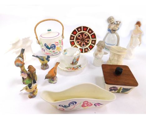 A group of ceramics, including a Poole Pottery biscuit barrel, traditionally decorated with flowers, three Royal Worcester Po
