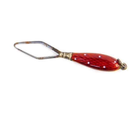 A silver and enamel needle threader, with red and white enamel handle, 6cm H.