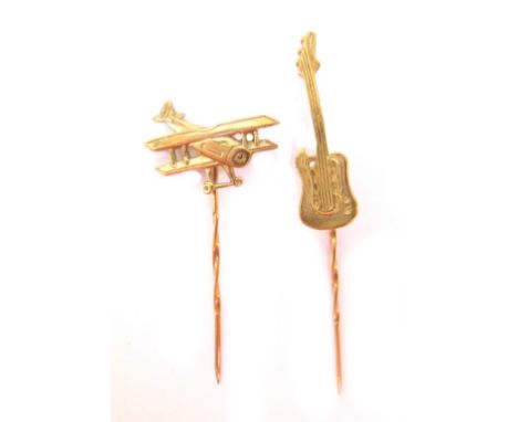 Two stick pins, comprising a 9ct gold guitar pin, 6cm high overall, and a 9ct gold aeroplane pin, 4cm high overall, 2.7g all 