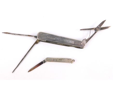 A George V silver cased folding scissors with needle and file, with engine turned decoration, reserve named to F H Cook, Shef