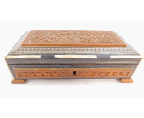 An early 20thC Indian carved hardwood box, with mother of pearl and ivory inlay, of rectangular section, the lid decorated wi