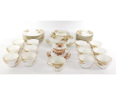 A Staffordshire late 19thC pottery tea service, of spiral fluted form decorated with flowers, gilt heightened, comprising a p