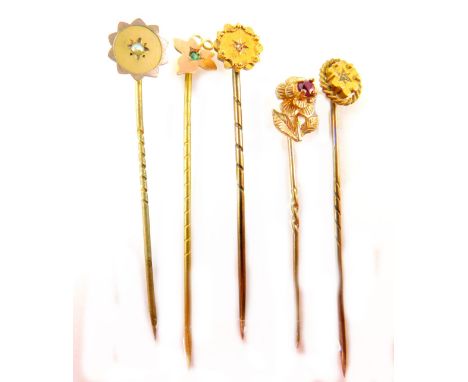 Five stick pins, comprising a a leaf and peridot 9ct pin, a 9ct flower pin, and three Victorian style pins, yellow metal, unm