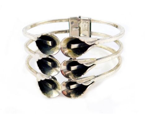 A Renoir Sterling Silver bangle, of hinged form, with a design of six flowers, 6cm dia.