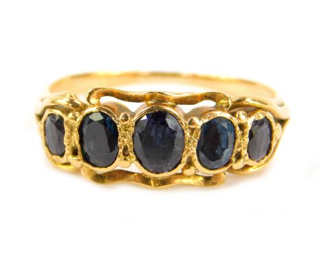 A sapphire five stone ring, with five oval cut sapphires, set in yellow metal, in a rub over setting, size I, 2.1g. 