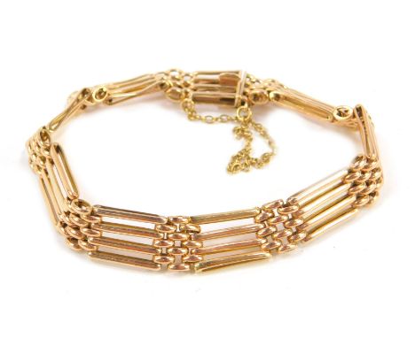 A 9ct gold four bar gate bracelet, on a snap clasp, with safety chain as fitted, 11.4g.