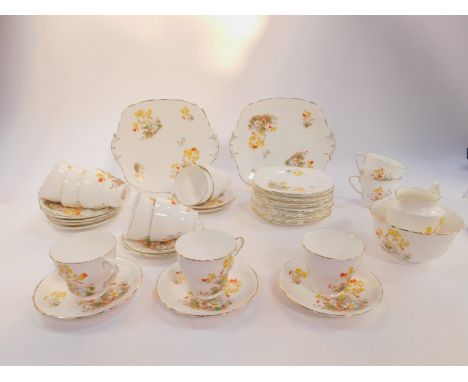 A Royal Stafford early 20thC porcelain part tea service, printed and painted with flowers, printed mark, comprising cream jug