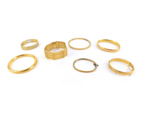 Seven bangles, comprising four hinged bangles, plated, a etched floral design bangle, and a heavygold plated bracelet.