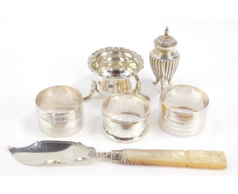 A George III silver and mother of pearl butter knife, Birmingham 1827, three serviette rings, Victorian silver fluted peppere