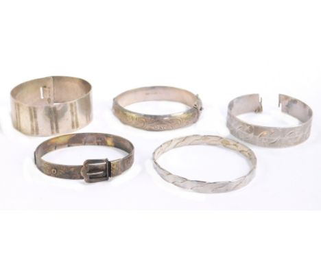 Five silver bangles, comprising a modern silver etched bangle, makers mark L.S.A., a silver bangle with etched star design, m