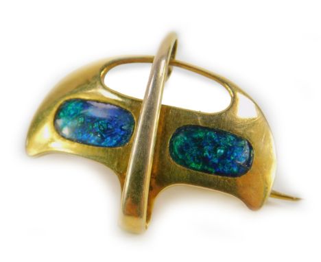 A 9ct gold Arts and Crafts brooch by Murrle Bennett Ltd, of scrolling shield form with two enamel panels, makers mark, 3.8g.
