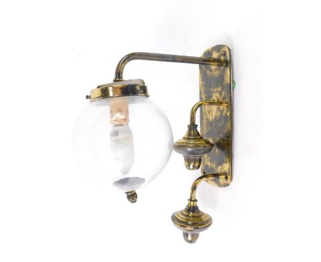*A brass wall light, with a clear glass globe shade, 35cm H.