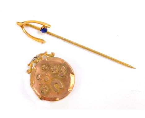 Two items of Victorian jewellery, comprising a wishbone stick pin, set with blue stone, yellow metal, unmarked and a locket w