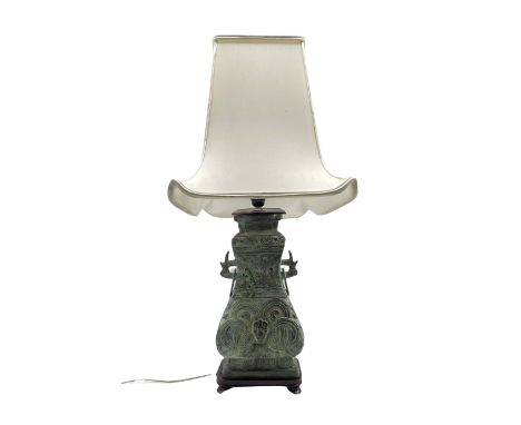 Chinese Archaic style bronzed twin handled table lamp, on hardwood plinth with shade, H84cm overall 