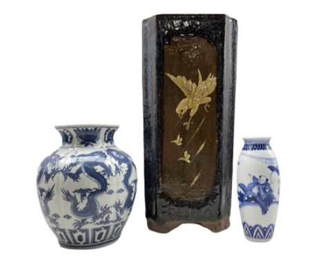 Chinese blue and white Dragon vase of lobed form, another Chinese blue and white vase and an Oriental stoneware stick stand d