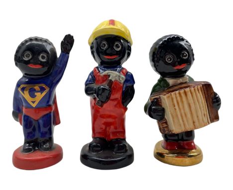 Three Carlton Ware Gollies, Superman, Builder and another playing the accordion  H9.5cm max (3)