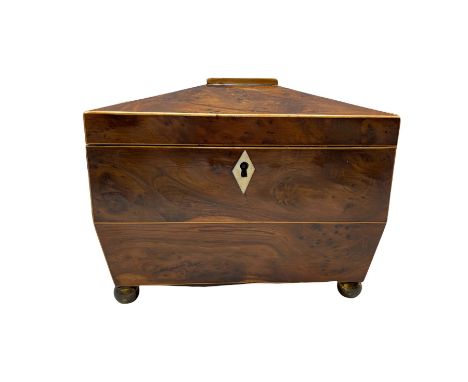 George III burr yew wood sarcophagus shape tea caddy, the interior with two covered containers, ivory escutcheon, metal ring 