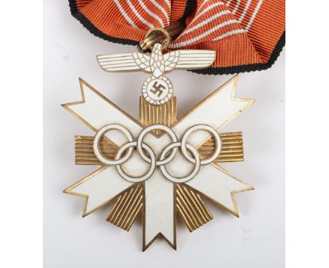 German 1936 Olympics Decoration, gilt and enamel example, complete with the full length neck ribbon. Construction indicates t