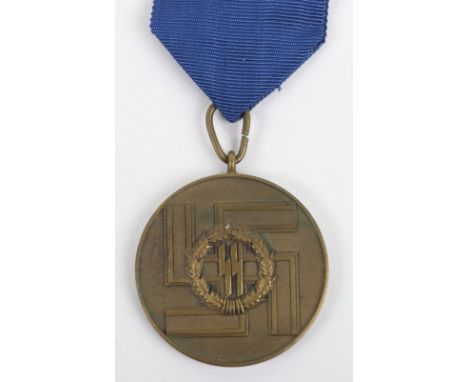 Third Reich SS 8 Year Long Service Medal, bronze medal with pear drop ribbon ring. Blue cornflower ribbon with stitched pin b