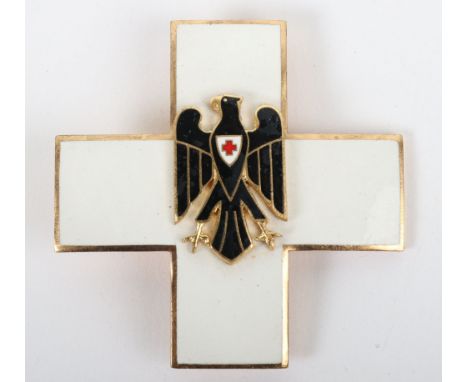 German Red Cross (D.R.K) Award, gilt and enamel breast badge award with black enamel down winged eagle and red cross to breas