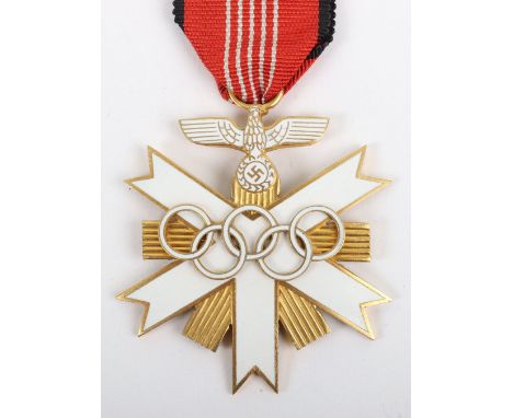 German 1936 Olympics Decoration, being the gilt and enamel medal, complete with its ribbon. Construction indicates that this 