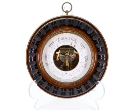 Price & Morse,1 & 2 Broadway Bristol; an Edwardian circular carved and moulded walnut case barometer, 23cm diameter.