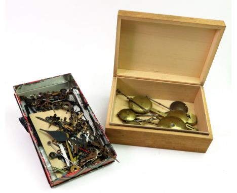A large collection of 19th & 20th century clock hands and ten various brass pendulums (qty).