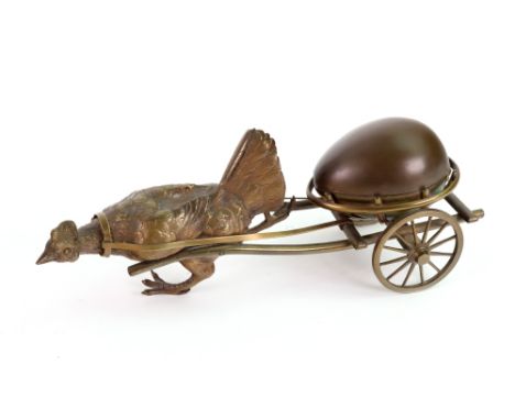 A novelty gilt metal inkwell, late 19th century, probably French, in the form of an egg, the hinged top enclosing a ceramic l