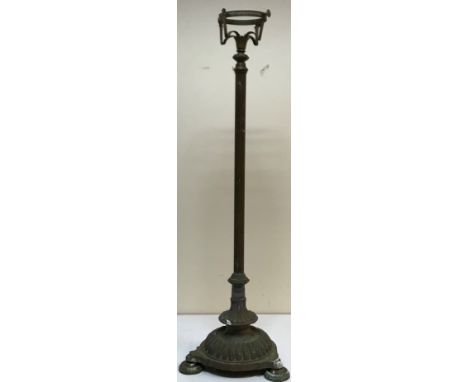 A circa 1900 brass oil lamp standard on a reeded column to tri-form reeded base and circular feet, 129 cm high (no lamp)
