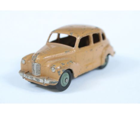 Dinky Austin Devon diecast model in tan body with scarce olive hubs, showing paint wear and chips