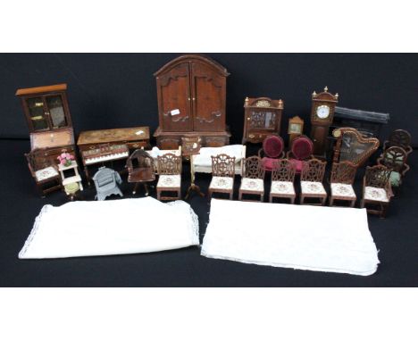 Collection of dolls house furniture to include two door and four drawer gun cabinet with guns, cast iron range, chairs, clock