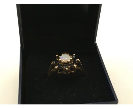 A 9 carat opal garnet ring. 3.1g. Size P. Postage category A
