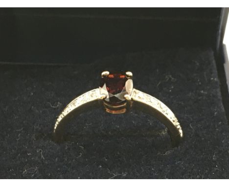 A 9 carat ruby and diamond shard set ring, size P. 2.1g Postage category A