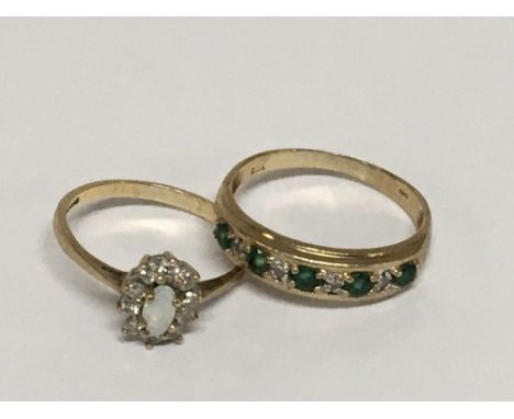 Two 9carat gold rings set with emerald diamonds the other ring with a central Opal (2)