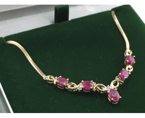 A 9ct yellow gold oval ruby and RBC diamond necklace, rubies 1.50ct approx. Diamonds 0.10ct approx. Weight 4.5g. Postage cate