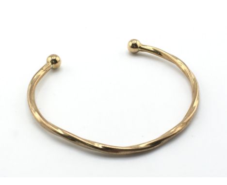 A 9ct gold bangle with possible metal core. 11g