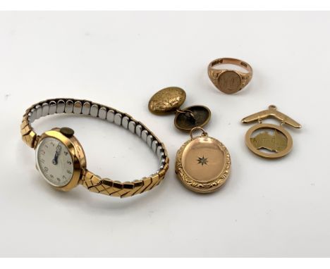 A mixed lot to include a 9ct gold cased ladies watch, 9ct gold back and front locket, 15ct gold single cufflink, 9c gold sign