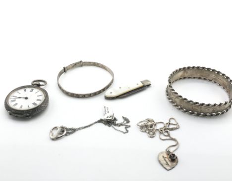 A silver bangle and silver chains along with other oddments. Postage B