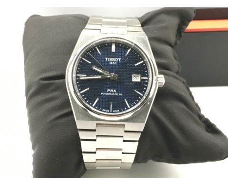 A tissot PRX powermatic 80 wrist watch with box and paperwork. Postage B