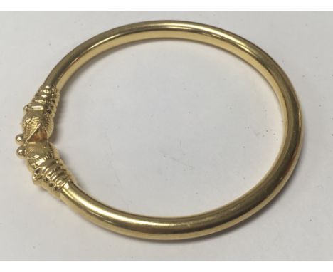 A Indian gold bangle total weight 22 grams.