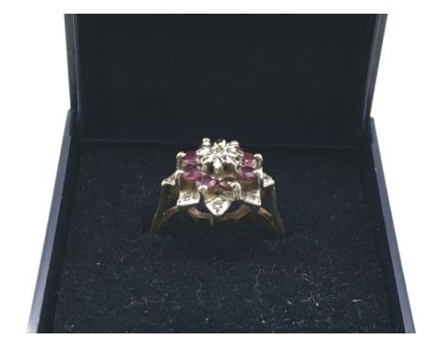 A 9 carat gold diamond and ruby ring, size K