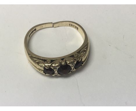 A 9 ct gold ring inset with garnets total weight 2.5 grams