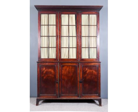 A Late Georgian Mahogany Bookcase, the upper part with moulded overhanging cornice above key pattern frieze, fitted six adjus