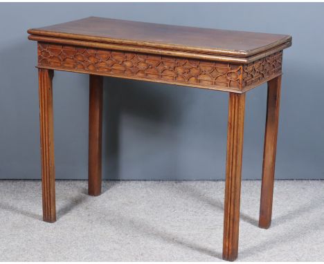 A George III Mahogany Rectangular Card Table, with baize lined folding top, moulded edge, apron with blind fret ornament, and